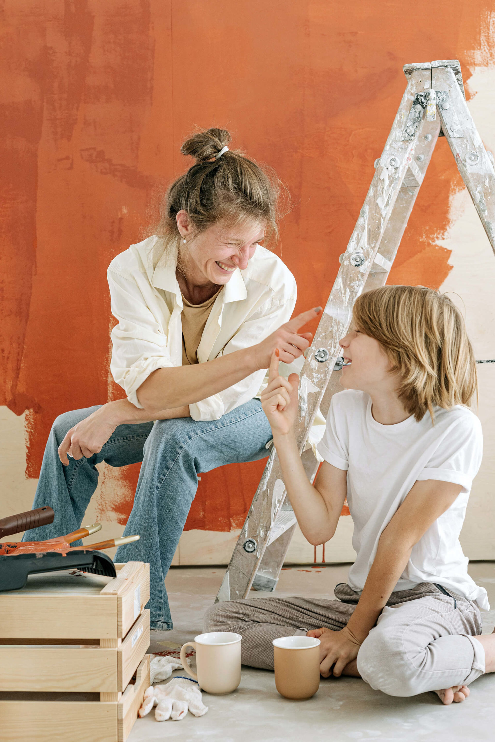 Mother painting walls with son