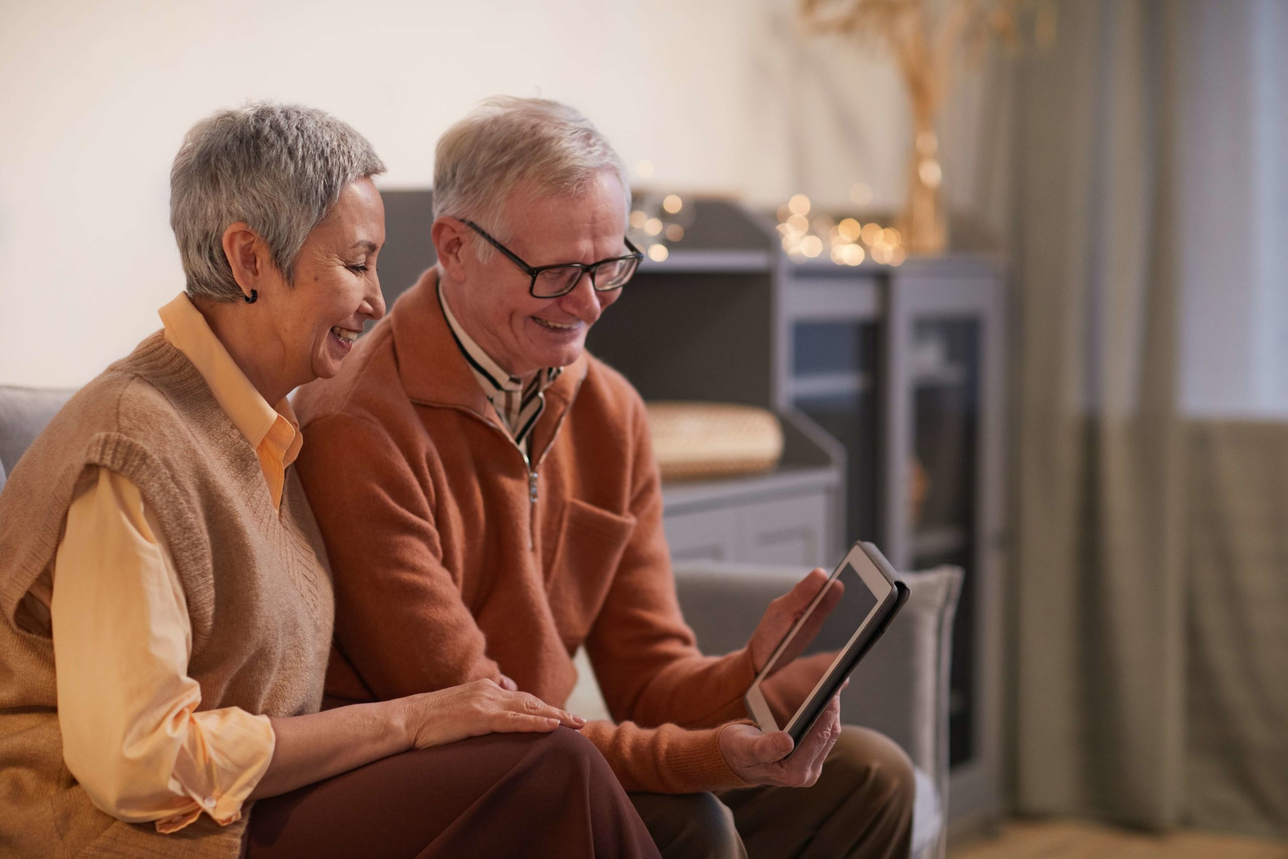 Elderly couple browsing their tablet for insurance plans