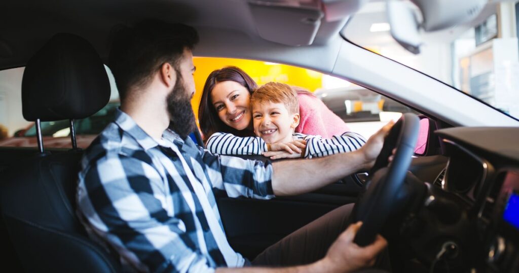 Happy family buying a new car at the car showroom.