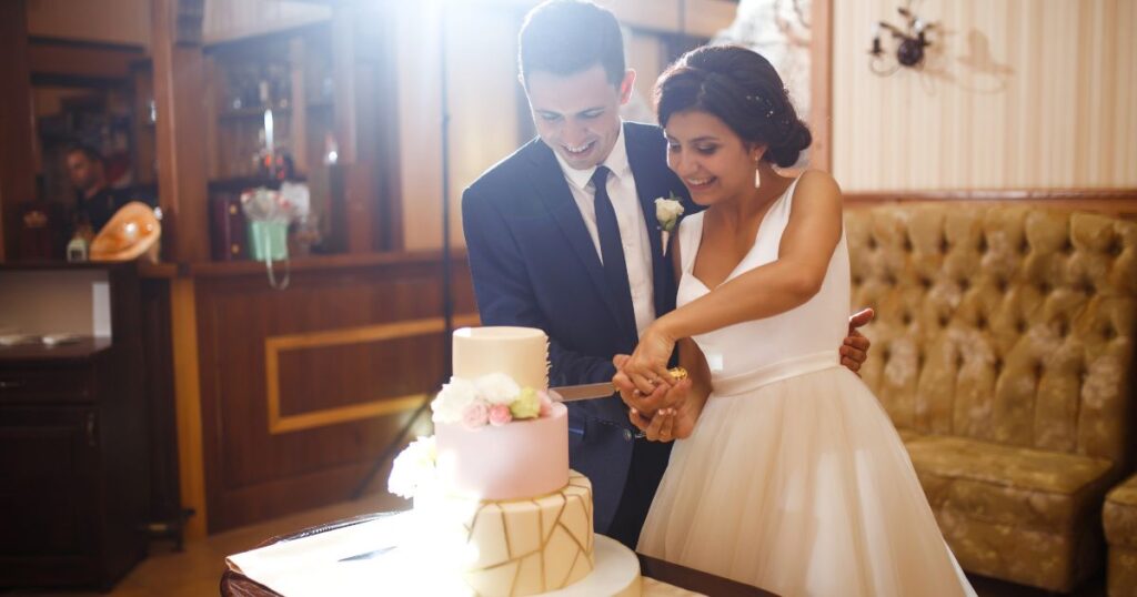 Married couple cutting the cake